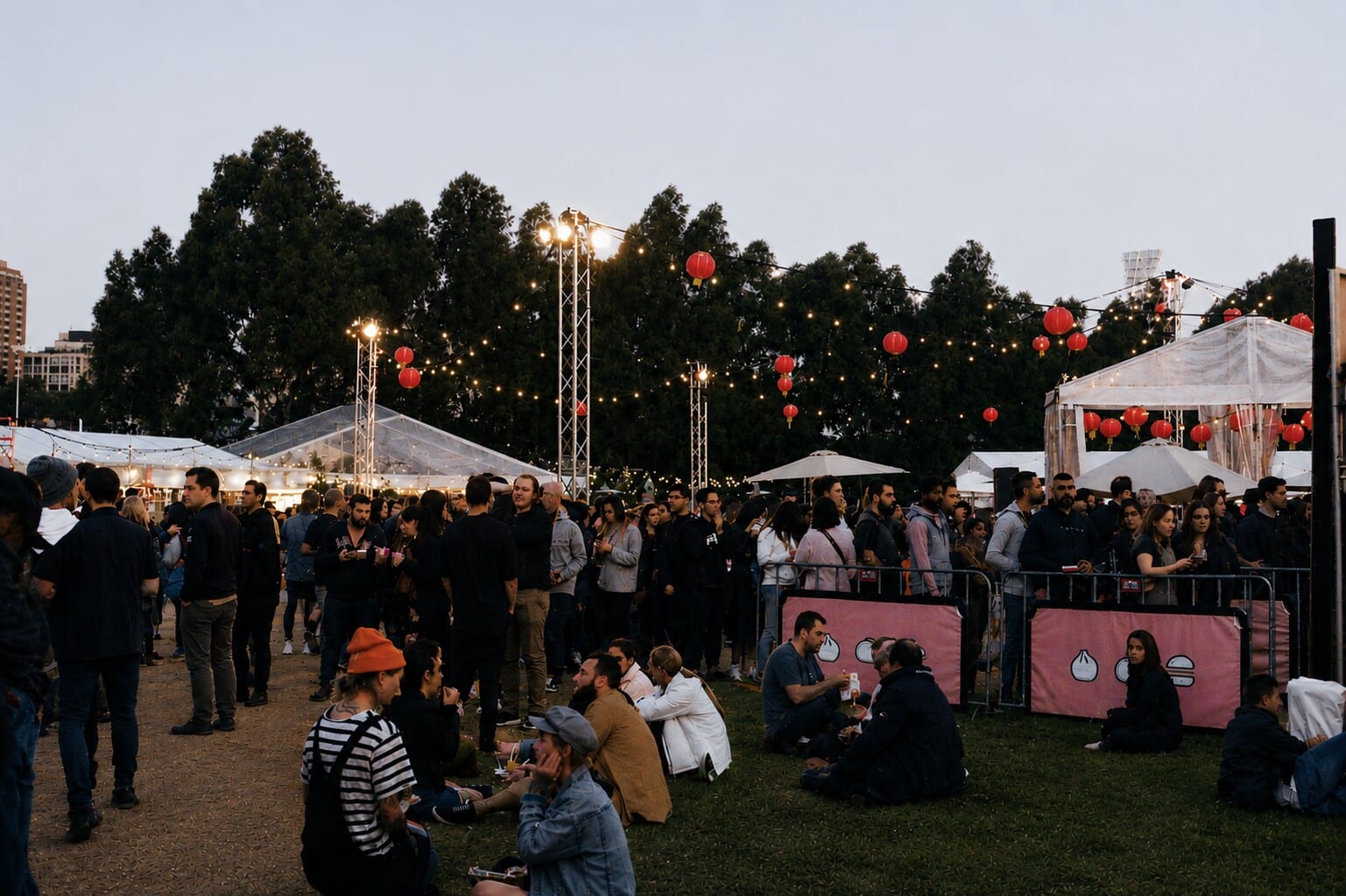 Outdoor event with food stalls and string lights